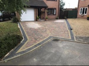 some work carried out last month for a bock paved driveway with a black border finished off to the road